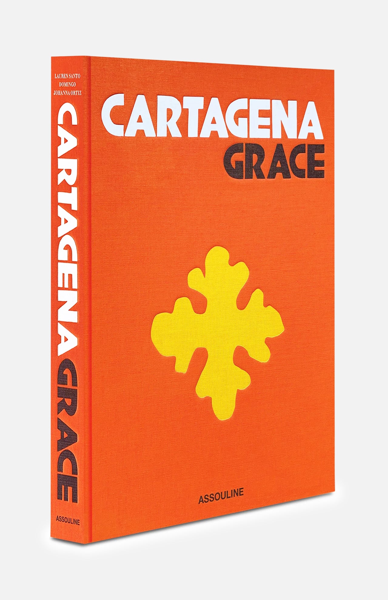 A vibrant orange hardcover book titled Cartagena Grace by ASSOULINE, featuring bold white and black lettering alongside a prominent yellow abstract design on the cover. The design and details evoke the lively spirit of Cartagena’s iconic architecture and honor the city’s distinction as a UNESCO World Heritage Site.