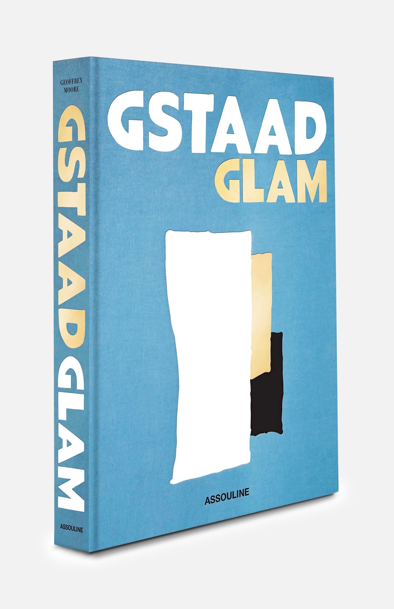 A blue hardcover book titled “Gstaad Glam” by ASSOULINE, inspired by the luxurious Swiss Alps resort and featuring abstract white, gold, and black shapes on the cover.