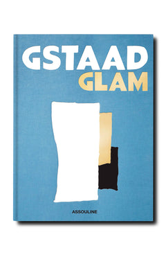 A blue book cover titled "Gstaad Glam" in bold white and yellow, by ASSOULINE, features abstract white, beige, and black shapes suggesting the Swiss Alps and luxury resort style.