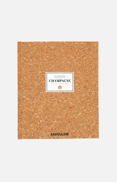 The Impossible Collection of Champagne by ASSOULINE is a square book with a cork-textured cover celebrating the artistry of French wine, featuring the brand name ASSOULINE at the bottom.