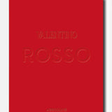 A bold red book cover featuring the embossed title “Valentino Rosso” at its center and the brand name “ASSOULINE” at the bottom, celebrating the timeless elegance and enduring legacy of Rosso Valentino in haute couture. The background is light gray.