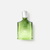 A green glass bottle of CREED Original Vetiver perfume with a silver cap is shown against a plain white background—a timeless vetiver fragrance.