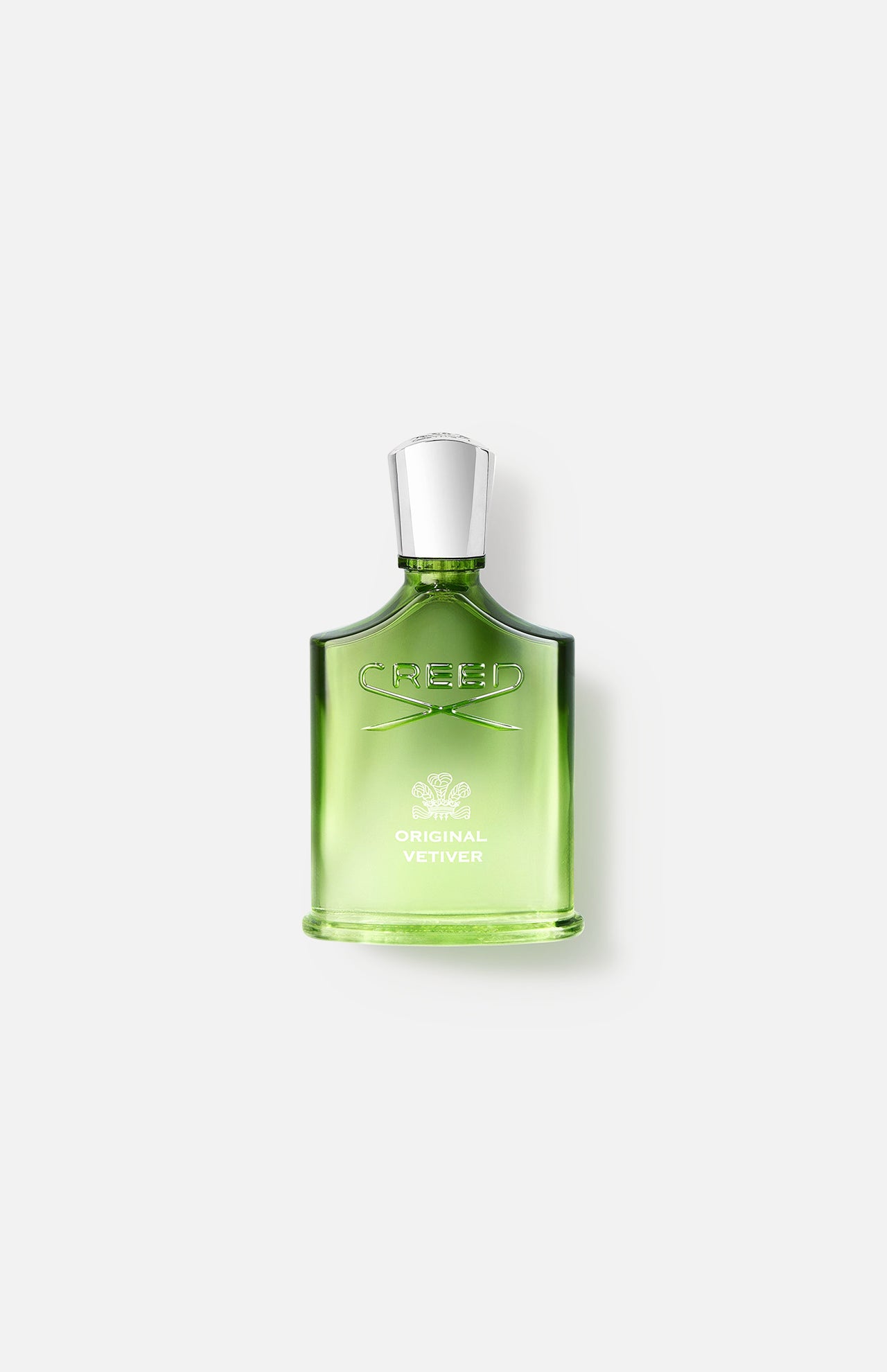 A green glass bottle of CREED Original Vetiver perfume with a silver cap is shown against a plain white background—a timeless vetiver fragrance.