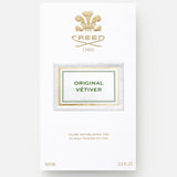 A white and gold box of CREED Original Vetiver displays the brand’s crest, 1760, and product details. This elegant box holds 100 ml (3.3 fl oz) of CREED’s signature vetiver Eau de Parfum.