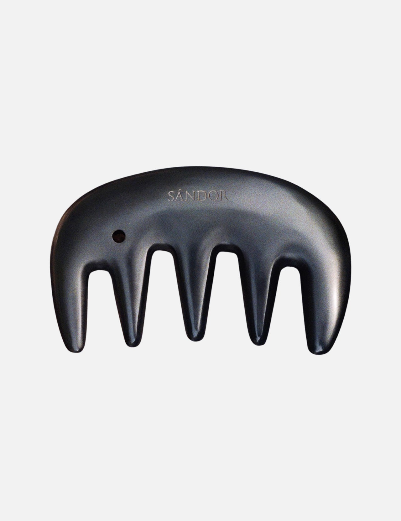 A black Gua Sha Comb by SÁNDOR, featuring four wide prongs and the brand name engraved, inspired by traditional Gua Sha techniques, is displayed against a plain white background.