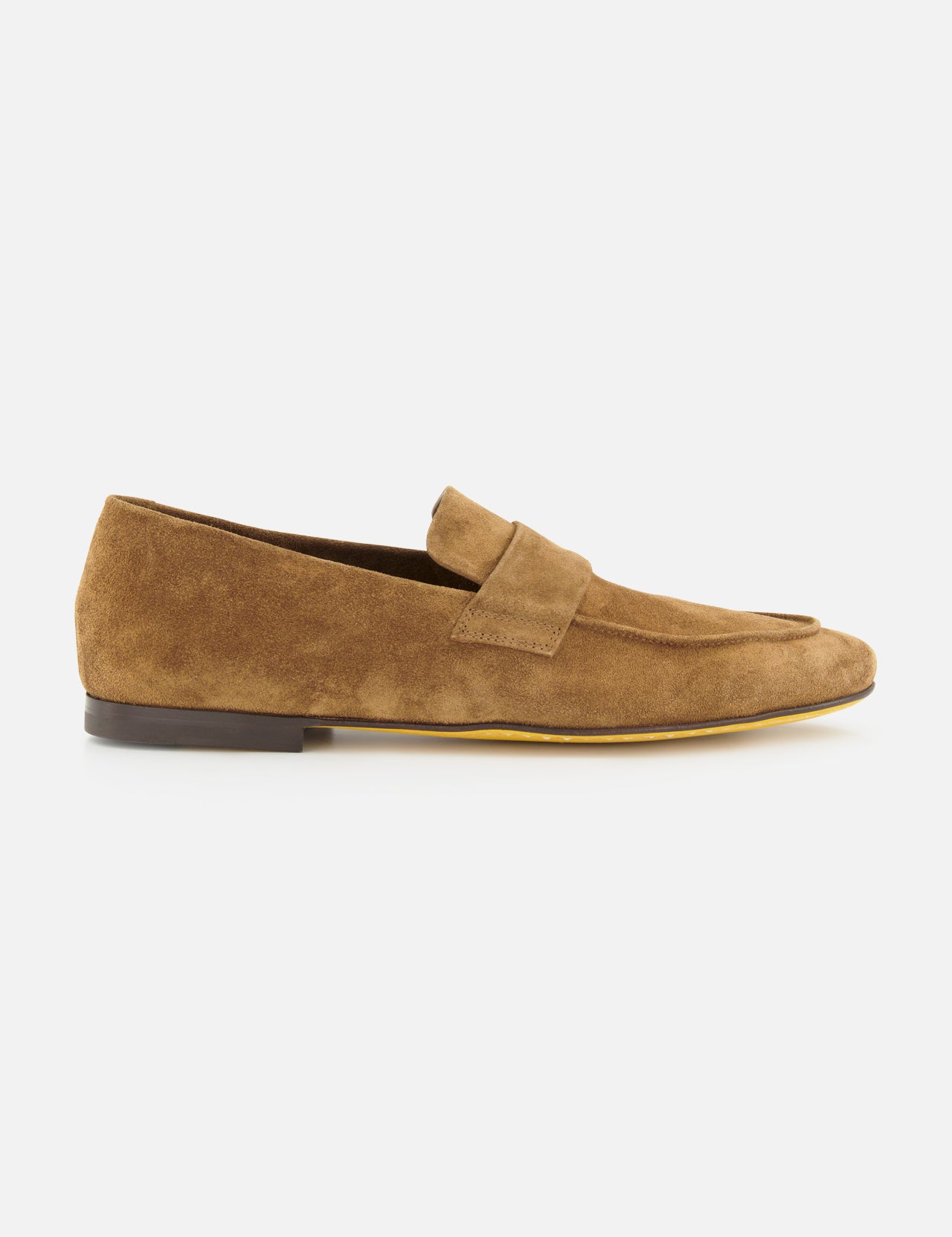 The Airto Suede Penny Loafer by OFFICINE CREATIVE is a tan brown Italian-made shoe with a low black heel and minimalist design, shown in profile on a plain white background.