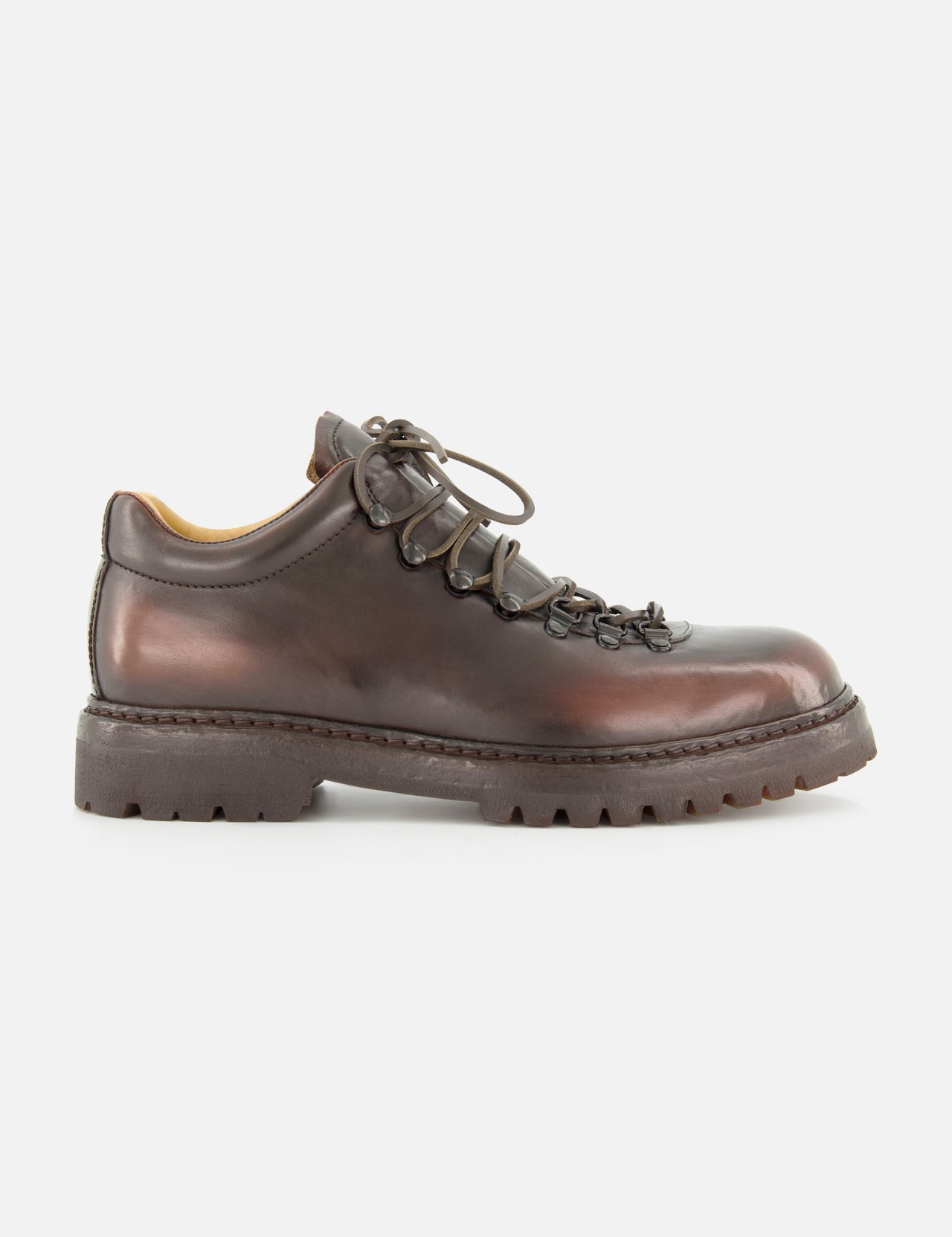 The OFFICINE CREATIVE Artik Flex Lace Low Boot is displayed in side profile on a white background, showcasing its brown leather construction, black laces threaded through metal eyelets, and a thick, rugged rubber sole—expertly handcrafted in Italy.