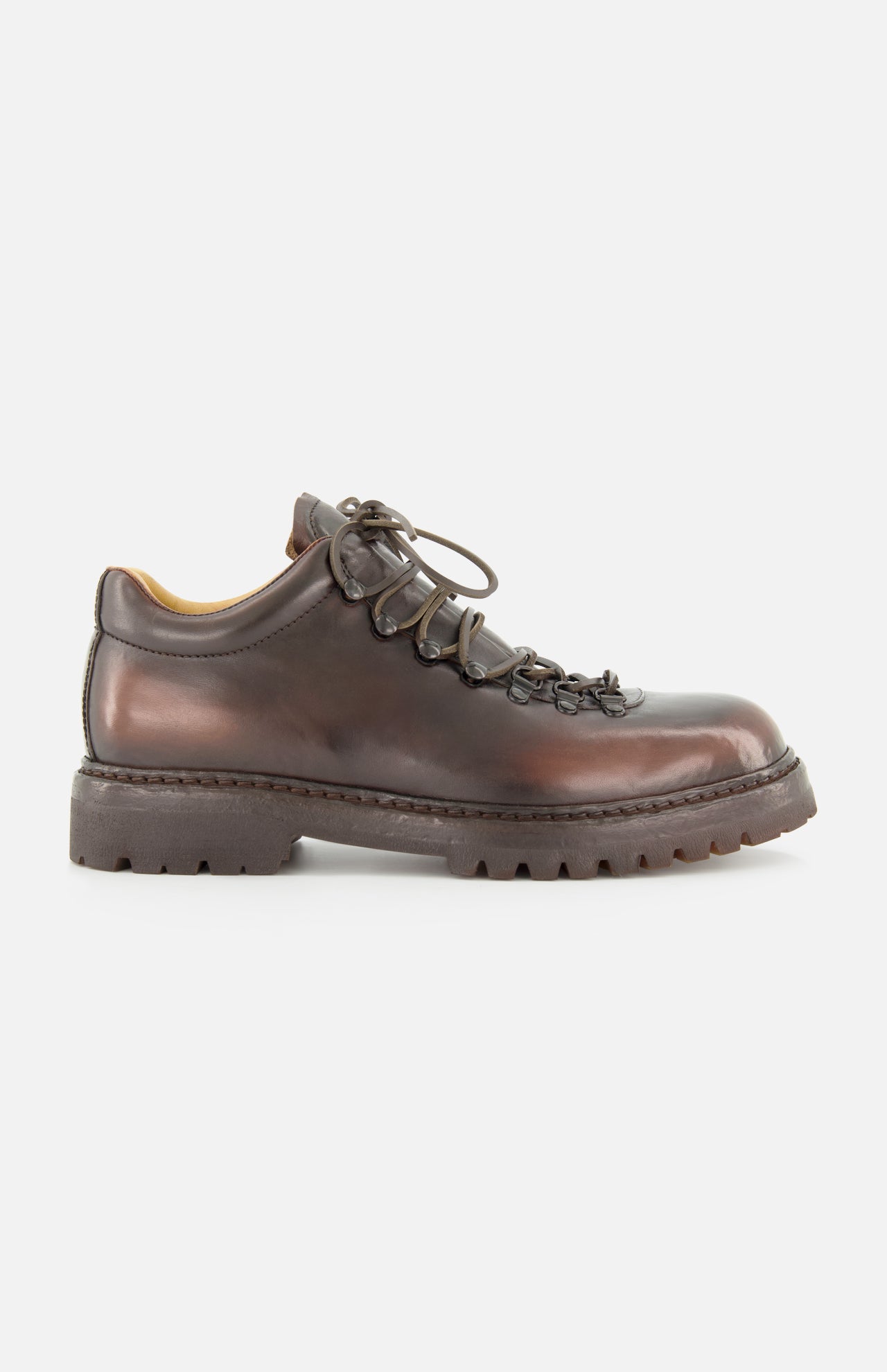 The OFFICINE CREATIVE Artik Flex Lace Low Boot is displayed in side profile on a white background, showcasing its brown leather construction, black laces threaded through metal eyelets, and a thick, rugged rubber sole—expertly handcrafted in Italy.