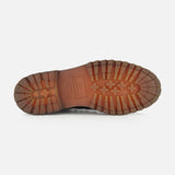 The image shows the sole of the OFFICINE CREATIVE Artik Flex Lace Low Boot, handcrafted in Italy, with a rugged tread pattern and a logo at the arch, photographed on a white background.