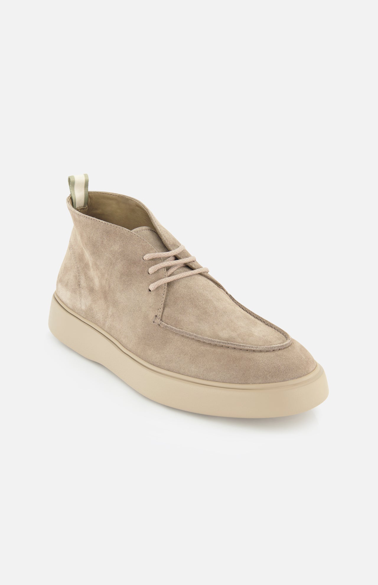 The OFFICINE CREATIVE Frame Suede Lace Chukka Boot is a tan suede boot featuring beige laces and a light rubber sole, handmade in Italy. Shown on a white background, the boot is angled to display both its side and front views.