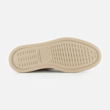 The beige sole of the OFFICINE CREATIVE Frame Suede Lace Chukka Boot features a textured grip pattern with fine horizontal grooves, photographed from the bottom against a plain white background. Branding is visible on the arch, showcasing the boot’s meticulous attention to detail and craftsmanship.