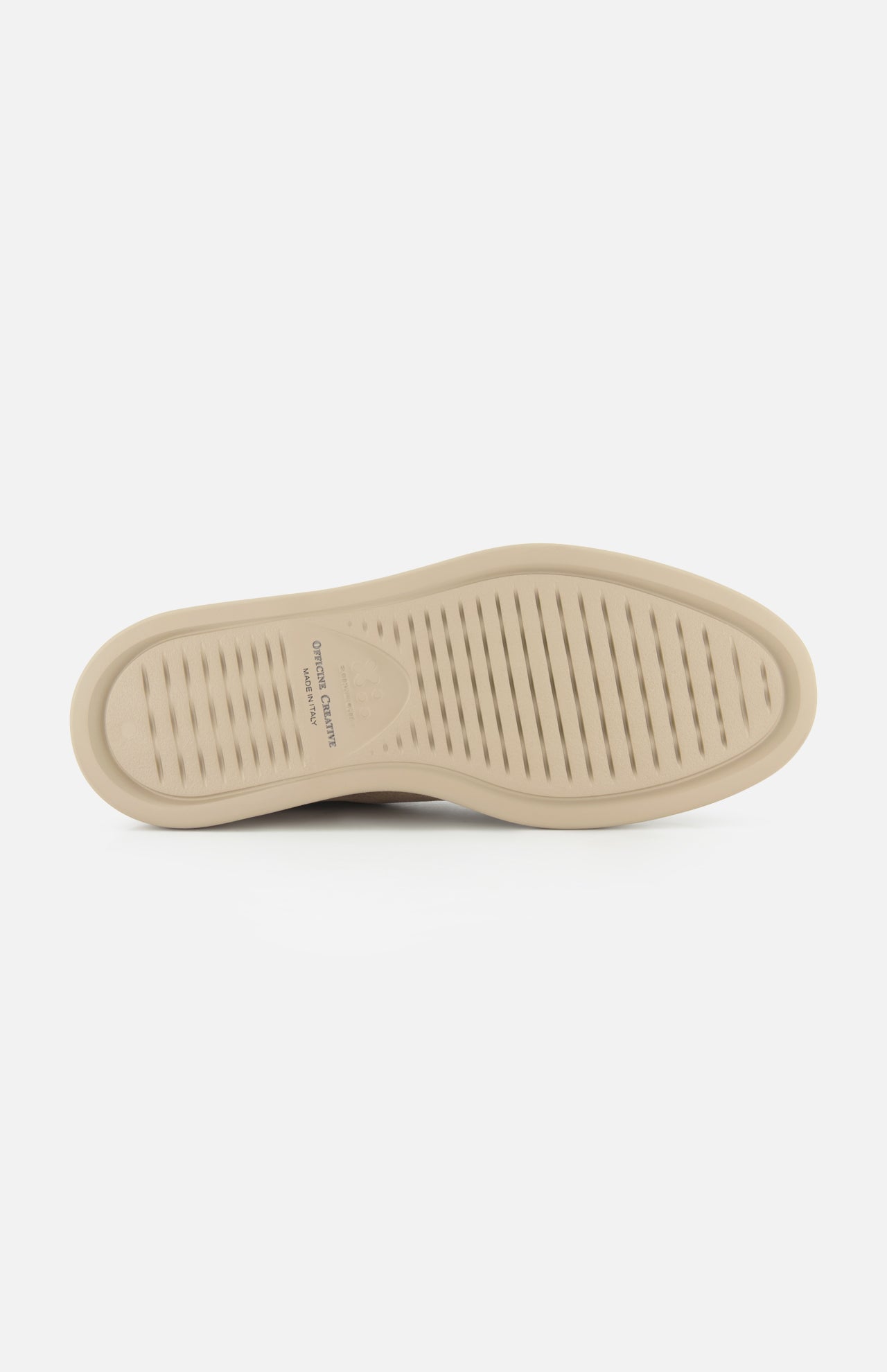 The beige sole of the OFFICINE CREATIVE Frame Suede Lace Chukka Boot features a textured grip pattern with fine horizontal grooves, photographed from the bottom against a plain white background. Branding is visible on the arch, showcasing the boot’s meticulous attention to detail and craftsmanship.