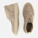 Two OFFICINE CREATIVE Frame Suede Lace Chukka Boots, handmade in Italy in beige suede with light tan rubber soles, are displayed on a white background—one boot shown from the side and the other viewed from above.
