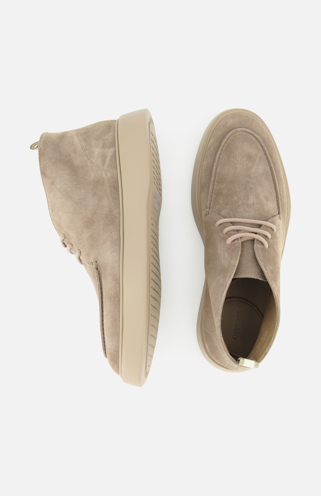 Two OFFICINE CREATIVE Frame Suede Lace Chukka Boots, handmade in Italy in beige suede with light tan rubber soles, are displayed on a white background—one boot shown from the side and the other viewed from above.
