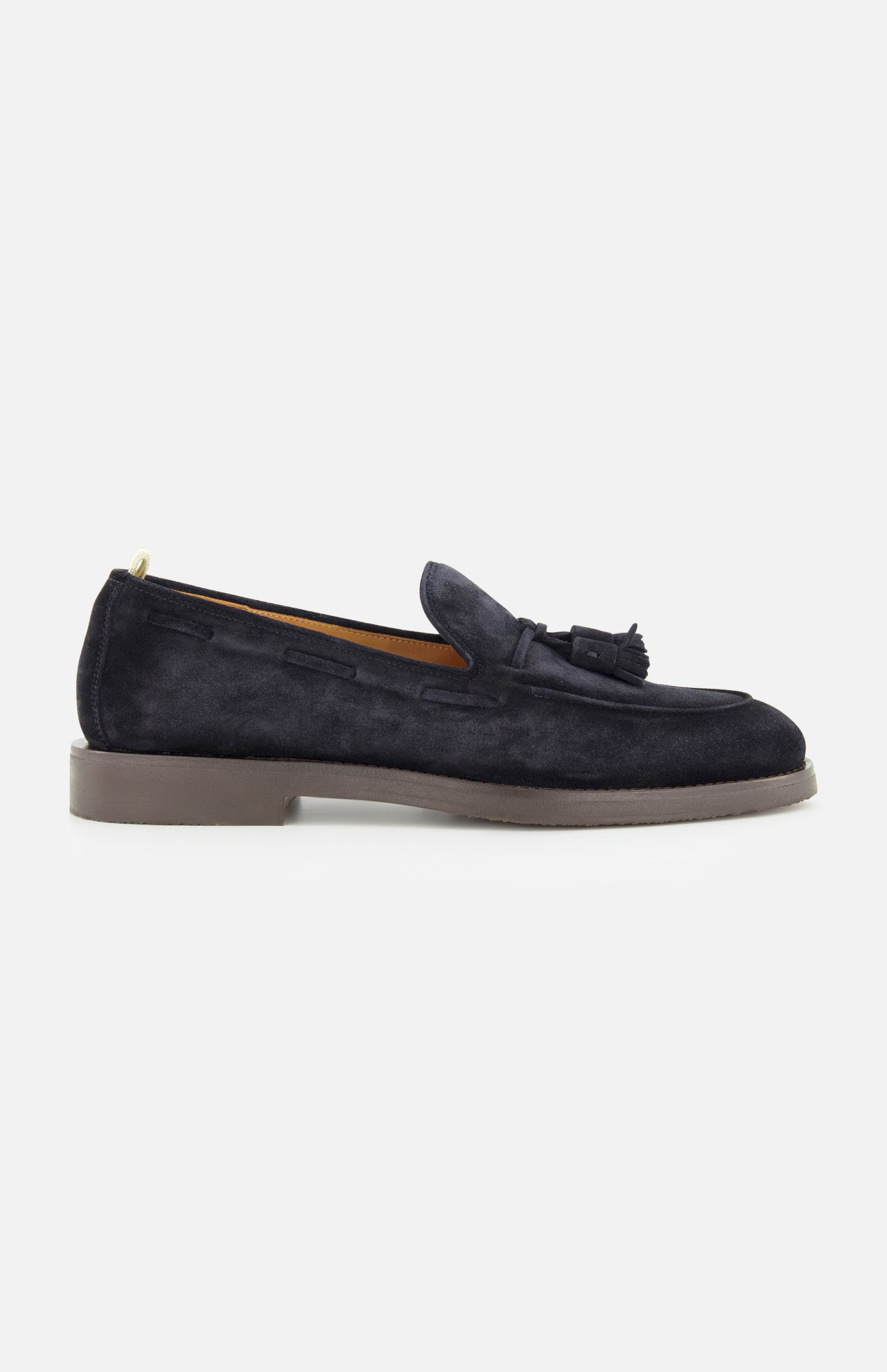 The OFFICINE CREATIVE Opera Flexi Tassel Loafer is crafted in dark blue suede with a tassel detail on top, featuring a round toe and a low heel, and is shown from the side against a plain white background.
