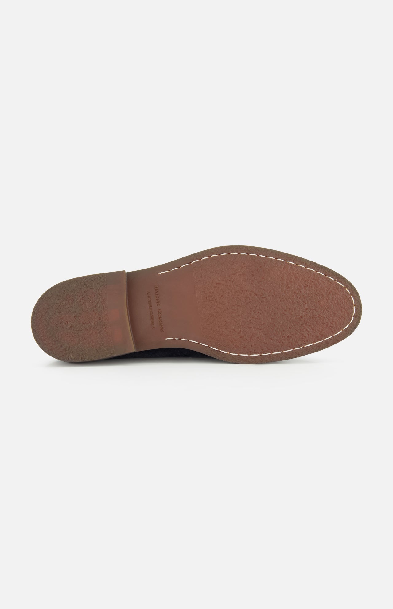 The image shows the bottom view of the Opera Flexi Tassel Loafer by OFFICINE CREATIVE, featuring a brown leather sole with visible stitching around the edge and a textured heel, characteristic of a classic Italian loafer.