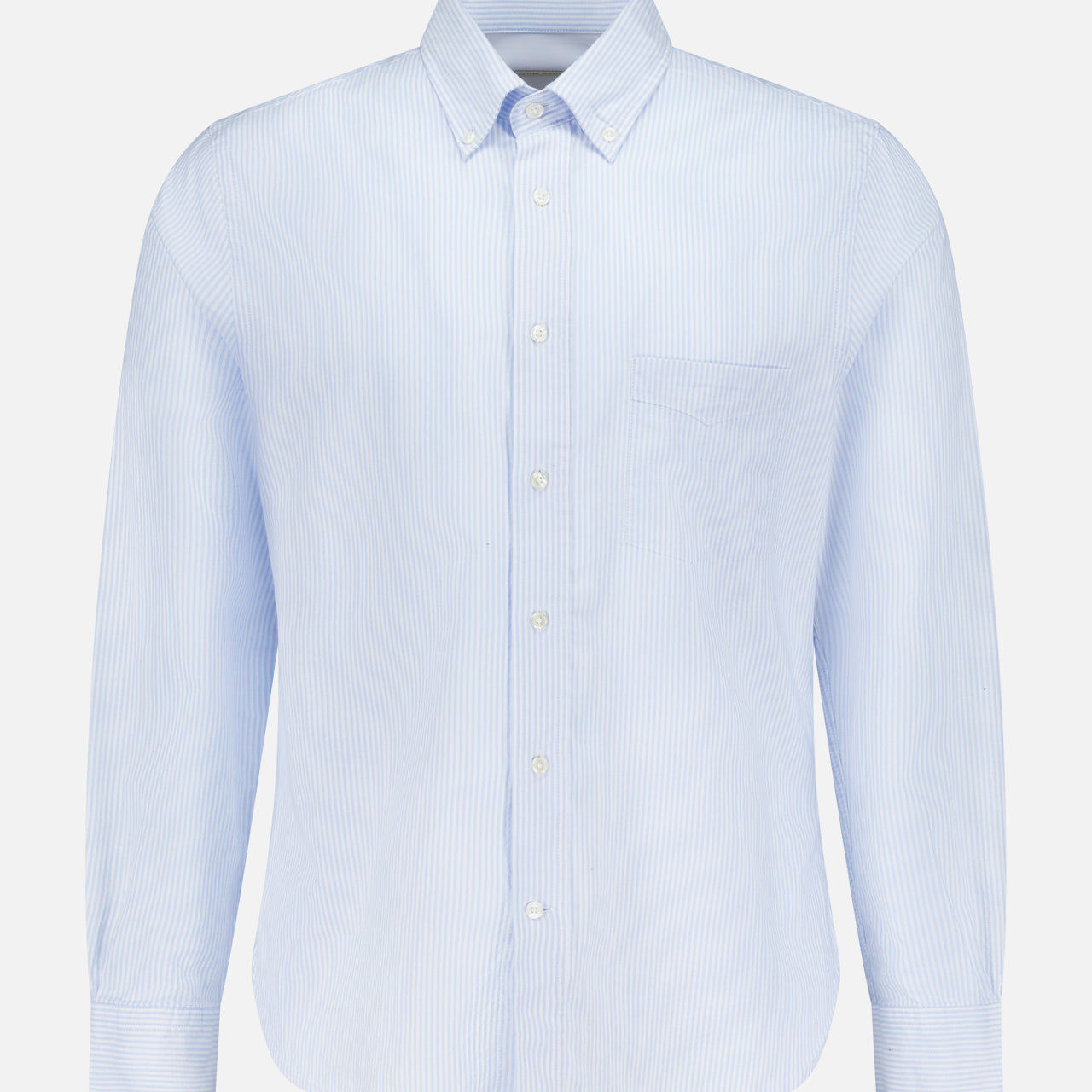 The Candy Stripe Oxford Shirt by OFFICINE GÉNÉRALE features light blue stripes, long sleeves, a classic collar, and chest pocket, crafted from fine Italian cotton for timeless Parisian style. Displayed on a plain white background.