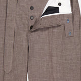 The Hoche Poplin Trouser Pant by OFFICINE GÉNÉRALE features a light brown shade, removable fabric belt, black buttons, white inner lining, and a branded label inside the waistband.