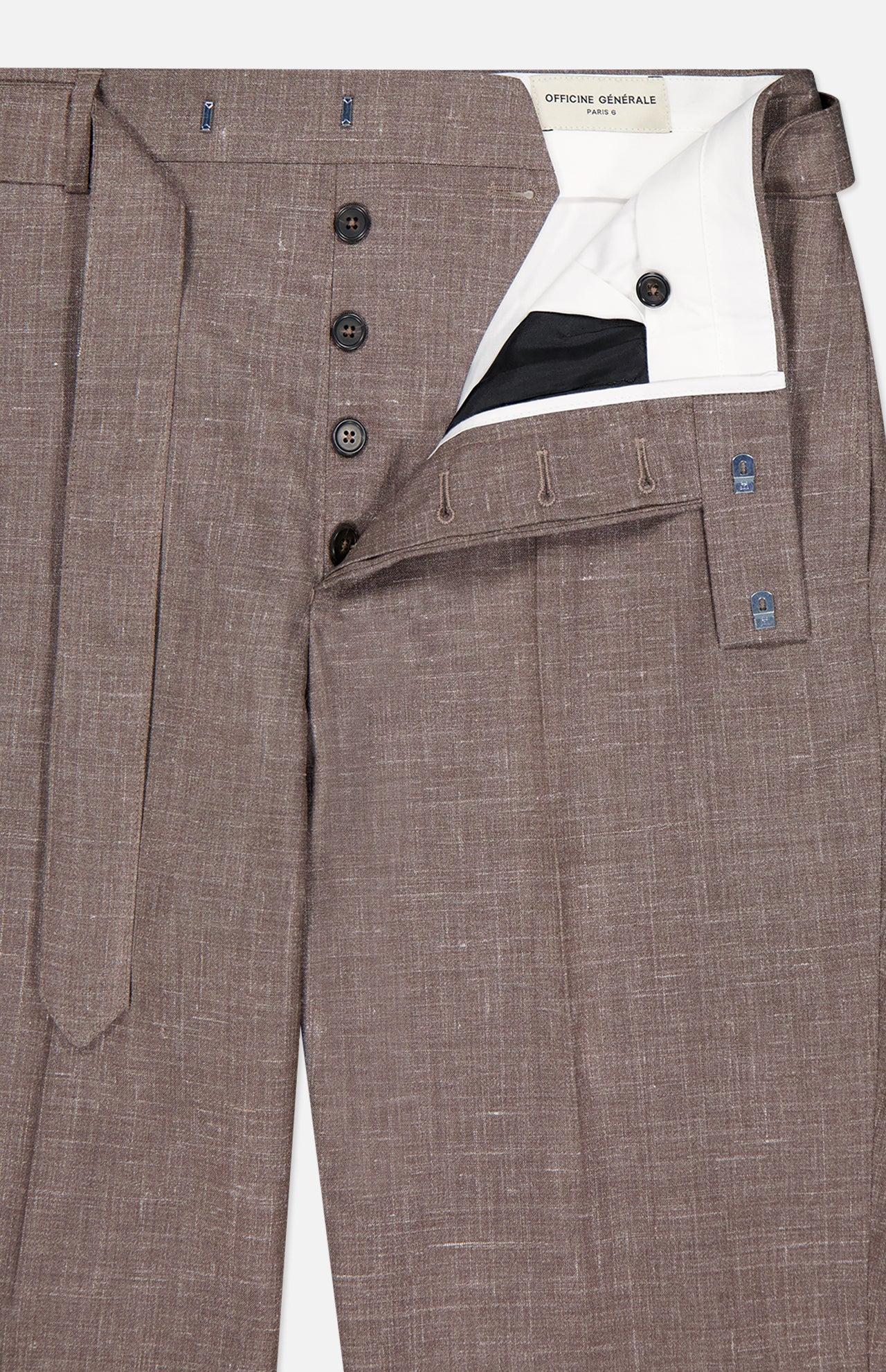 The Hoche Poplin Trouser Pant by OFFICINE GÉNÉRALE features a light brown shade, removable fabric belt, black buttons, white inner lining, and a branded label inside the waistband.