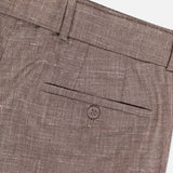 Close-up of the Hoche Poplin Trouser Pant by OFFICINE GÉNÉRALE in light brown textured fabric, featuring a single welt pocket with button, waistband belt loop, and removable fabric belt.