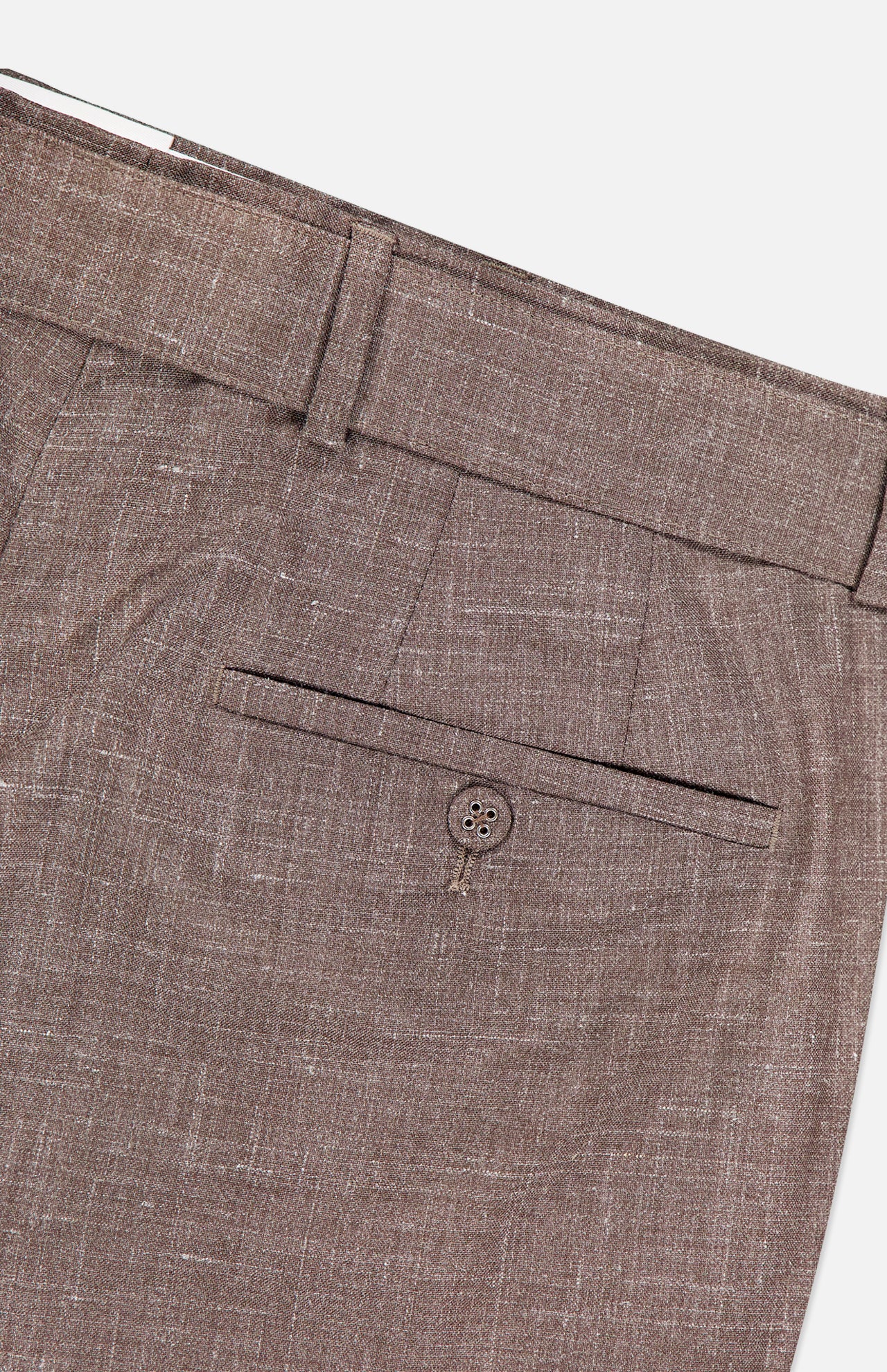 Close-up of the Hoche Poplin Trouser Pant by OFFICINE GÉNÉRALE in light brown textured fabric, featuring a single welt pocket with button, waistband belt loop, and removable fabric belt.