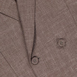 Close-up of the OFFICINE GÉNÉRALE Leon Double Breasted Poplin Blazer, showing the lapel, buttons, and pocket. The light brown fabric has a subtle crosshatch texture for added depth.