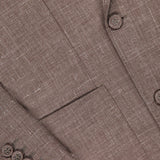 Close-up of the Leon Double Breasted Poplin Blazer by OFFICINE GÉNÉRALE in light brown textured fabric, featuring a lapel, two front buttons, four sleeve cuff buttons, and a front pocket.