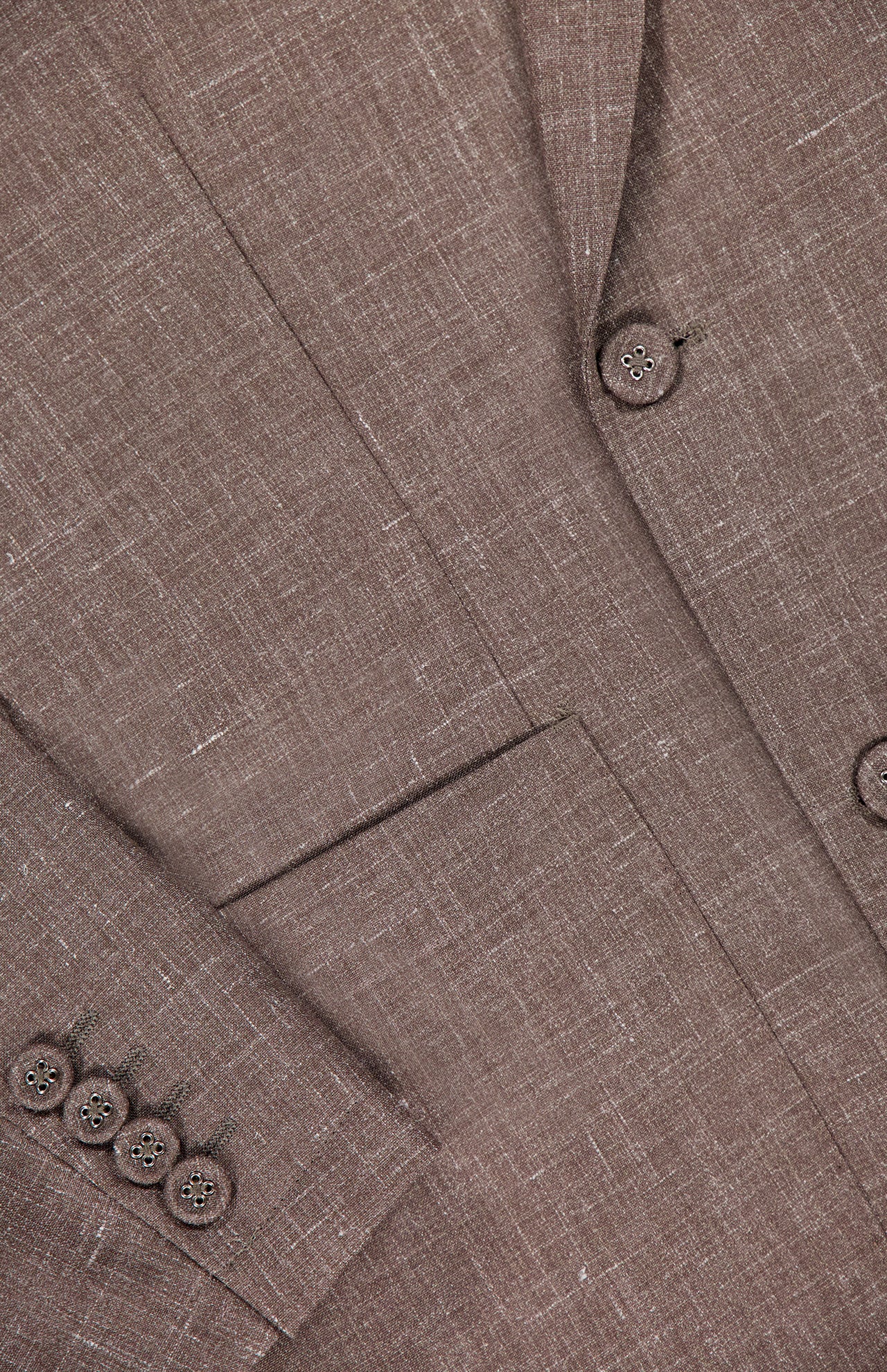 Close-up of the Leon Double Breasted Poplin Blazer by OFFICINE GÉNÉRALE in light brown textured fabric, featuring a lapel, two front buttons, four sleeve cuff buttons, and a front pocket.