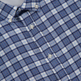 A close-up of the OFFICINE GÉNÉRALE Arsene Waffled Cotton Checkered Long Sleeve Shirt, featuring blue and white plaid with white buttons and a label inside the collar that reads OFFICINE GÉNÉRALE PARIS. This shirt is crafted from premium waffled stretch cotton for added comfort.