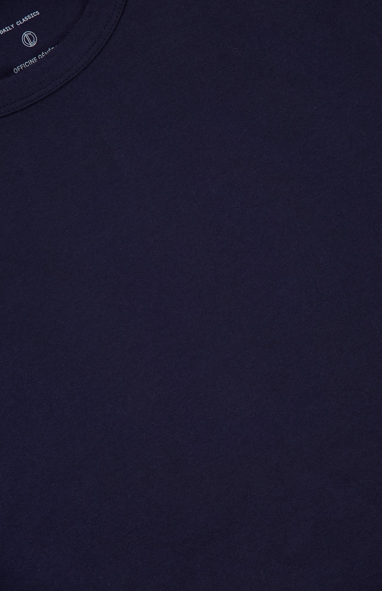 A close-up of the OFFICINE CREATIVE Cotton Crewneck T-shirt in dark navy blue showcases its smooth fabric texture and part of the neckline, highlighting this classic men's casual tee.