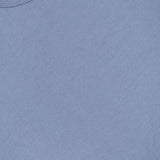A close-up view of the OFFICINE GÉNÉRALE Cotton Crewneck T-Shirt in light blue, crafted from soft organic cotton, highlighting the classic crew neckline and a small section of the label inside the collar.