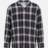 The Eren Long Sleeve Gaze Checkered Shirt by OFFICINE GÉNÉRALE features a navy blue, white, and gray plaid pattern. Made in Portugal, this classic camp shirt is designed with a traditional collar and front buttons, showcased against a plain white background.