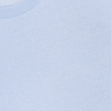 Close-up of the Garment Dyed Linen Short Sleeve T-shirt by OFFICINE GÉNÉRALE in light blue, featuring a visible neck label, soft textured linen fabric, clean stitching, and breathable comfort for summer.