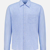 The OFFICINE GÉNÉRALE Guido Slub Cotton Shirt is a light blue, long-sleeve button-up with a chest pocket, classic collar, and white buttons, made from 100% cotton and shown on a plain white background.