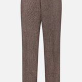 The Hoche Wool Trouser Pants by OFFICINE GÉNÉRALE showcase a light brown wool fabric with a subtle pinstripe, front crease, and belt loops, and include a removable belt made from matching material. These elegant trousers are displayed against a plain white background.