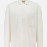 The OFFICINE GÉNÉRALE Jordy Pigment Brush Twill Long Sleeve Shirt is a plain white, loose fit shirt featuring long sleeves, a collar, three front buttons, and a single chest pocket, shown against a white background.