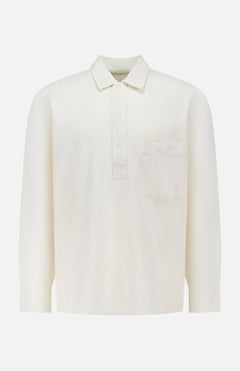 The OFFICINE GÉNÉRALE Jordy Pigment Brush Twill Long Sleeve Shirt is a plain white, loose fit shirt featuring long sleeves, a collar, three front buttons, and a single chest pocket, shown against a white background.