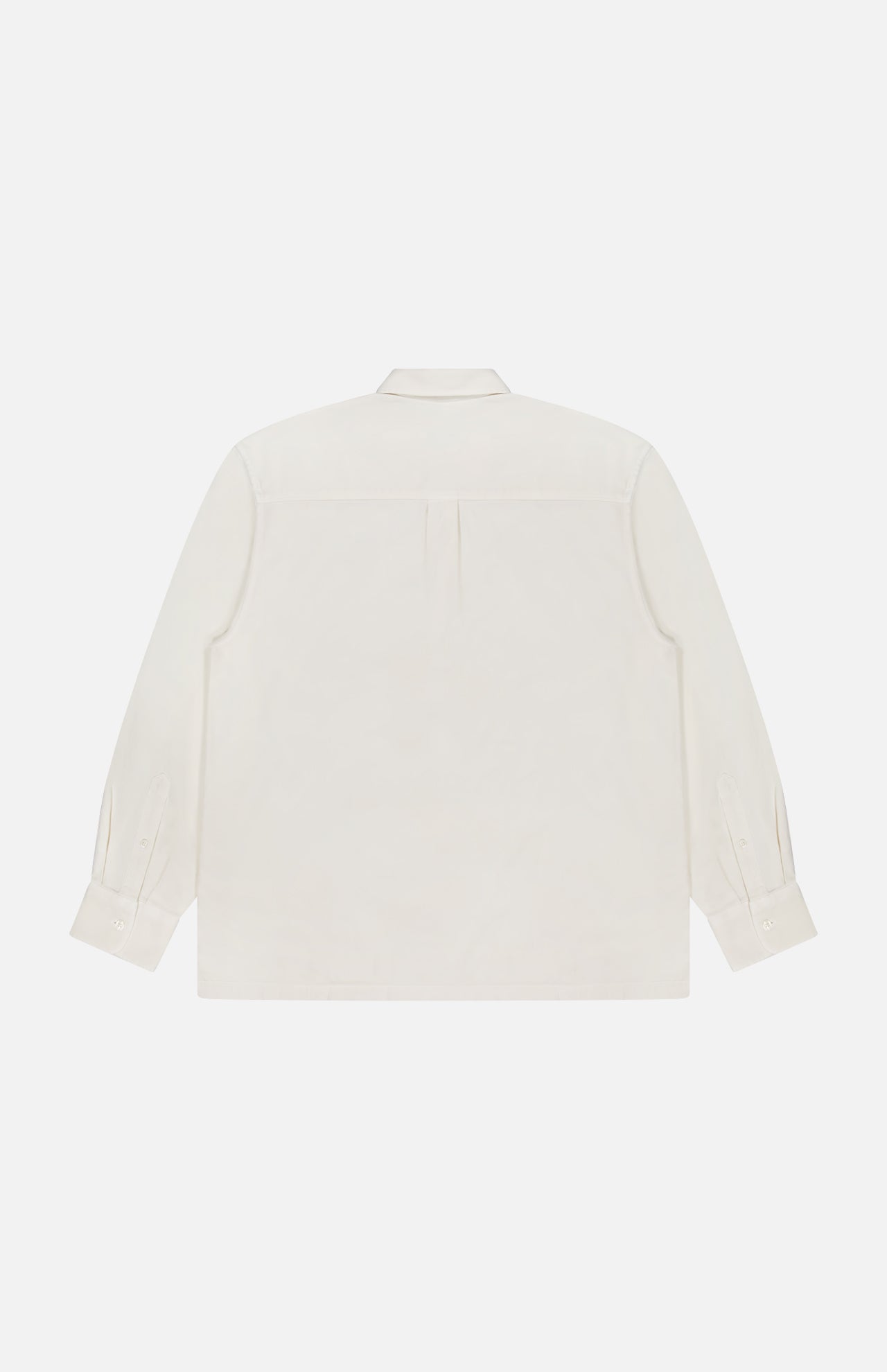 Back view of the Jordy Pigment Brush Twill Long Sleeve Shirt by OFFICINE GÉNÉRALE, crafted from cream cotton with a collar, single pleat at the upper back, long sleeves, and buttoned cuffs, displayed on a plain white background. This loose-fit shirt offers effortless style and comfort.
