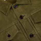 Close-up of the OFFICINE GÉNÉRALE Liam Goat Leather Suede Jacket in olive green, featuring brown buttons, two chest pockets, and a visible Daily Classics label.