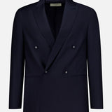 The OFFICINE GÉNÉRALE Merrick Twill Double Breasted Jacket is expertly tailored from virgin wool in a dark navy hue, featuring peak lapels, four front buttons, and two front pockets. It is showcased against a plain white background.