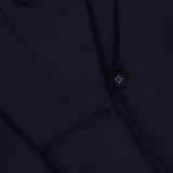 Close-up of the OFFICINE GÉNÉRALE Merrick Twill Double Breasted Jacket in dark navy, highlighting part of the lapel, a pocket, and several buttons on the sleeve and front. This tailored jacket is crafted from premium virgin wool for an elegant finish.