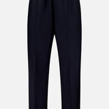 The Nelson Twill Trouser Pants by OFFICINE GÉNÉRALE feature a minimal, tailored design with straight legs, an elastic waistband, and a drawstring closure. Crafted from virgin wool, these black pants are displayed against a plain white background.