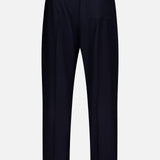 The Nelson Twill Trouser Pants by OFFICINE GÉNÉRALE are crafted from soft virgin wool in navy blue, featuring a comfortable elastic waistband, a single rear pocket, and a relaxed wide-leg silhouette. They are displayed against a plain white background.