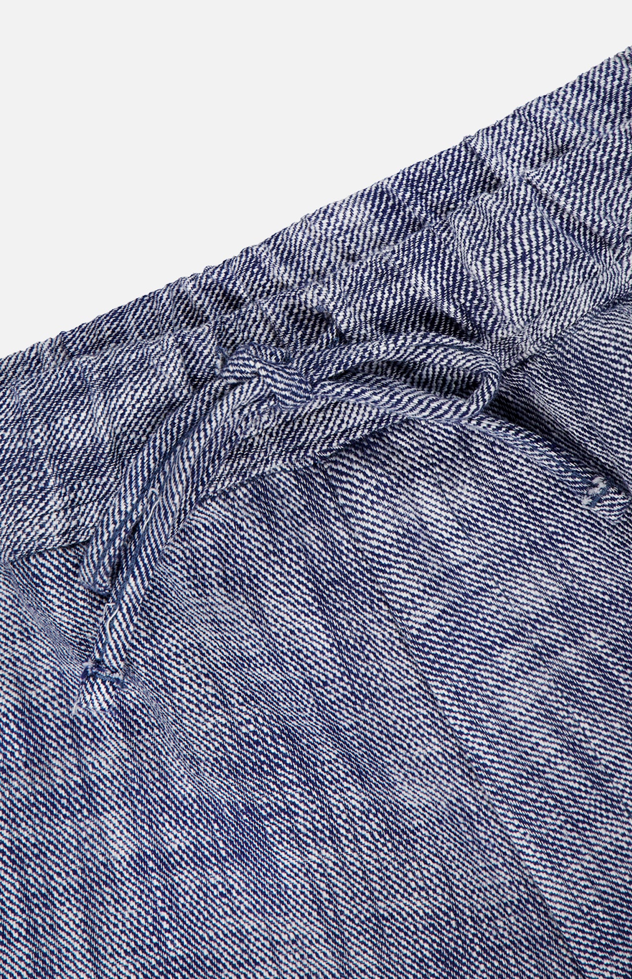 Close-up of OFFICINE GÉNÉRALE's Nilson Light Slub Trouser Pant in blue and white stripes, featuring a drawstring elastic waistband and lightweight textured fabric—ideal for relaxed wide-leg style.