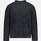 The OFFICINE GÉNÉRALE Riley Mockneck Sweater is a long-sleeved, dark gray and black marled knit sweater featuring a high neckline and relaxed fit, channeling a Parisian-inspired style and shown against a plain white background.