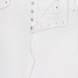 OFFICINE GÉNÉRALE Vintage Original Wash Denim Pants: off-white jeans with a partially open button fly revealing silver buttons, front pockets, classic 5-pocket design, and a visible inner label by the waistband.