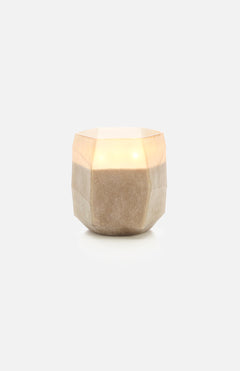 The ONNO Terre Light Smoked L Zanzibar Candle, a hand-poured candle in a faceted beige stone-like holder, is set against a plain white background.