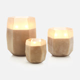 The ONNO Terre Light Smoked XL Zanzibar Candle glows warmly inside a faceted beige holder, creating an elegant display on a plain white background.