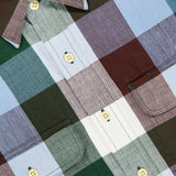 Close-up of the ORIGINAL MADRAS Check Long Sleeve Shirt, handwoven in pure Indian cotton with large green, burgundy, light blue, and white checks, yellow buttons, front pockets, and a yellow tag on the collar.