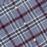 Here’s a rewritten sentence using the product data: Close-up of the ORIGINAL MADRAS Check Straight Collar Dress Shirt, showcasing its blue, gray, black, and red Madras check pattern in pure Indian cotton with white buttons and a partial view of the collar.